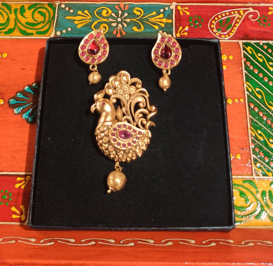 Antique Finish Peacock Pendant Set With Ruby Green Stones  And Matching Earrings